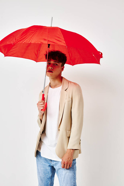 Man rain protection in hand in hand modern style light background unaltered - Valokuva, kuva