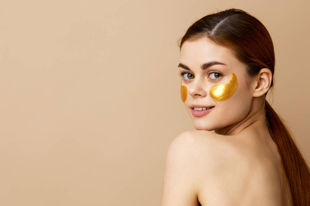 beautiful woman skin care face patches bare shoulders hygiene isolated background. High quality photo - Photo, Image