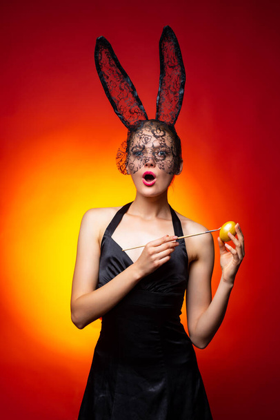 Easter bunny. happy easter. spring holiday. Egg hunt. painting traditional easter eggs. golden egg. wreath and finance. surprised woman in rabbit ears. sexy retro girl on red background. diy egg. - Photo, image