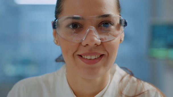 Biologist with safety goggles smiling at camera - 写真・画像