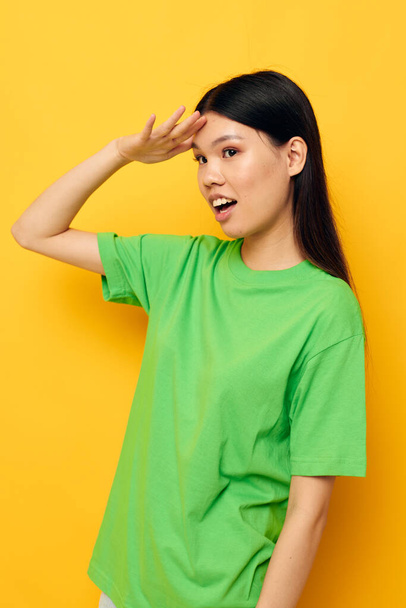 Portrait Asian beautiful young woman posing in green t-shirt emotions copy-space studio model unaltered - Fotoğraf, Görsel