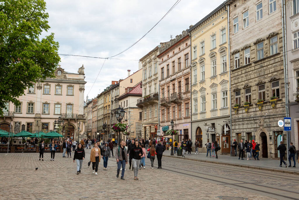 Lviv, Ukraine - May 14, 2021: People tourists walking by city square copy space - Фото, изображение
