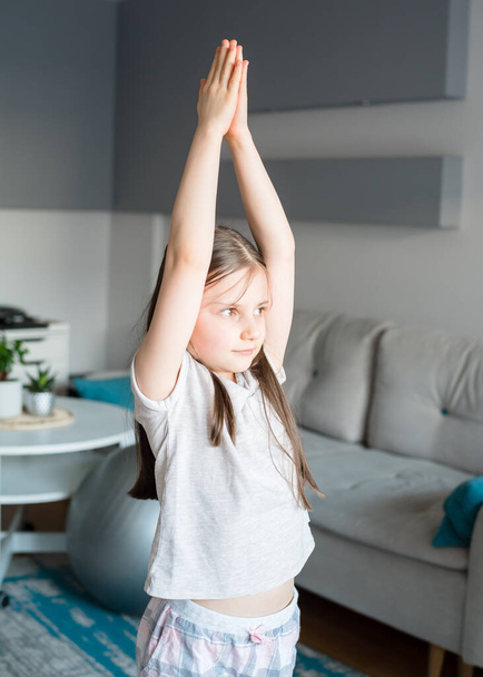 Girl doing stretching at home. Workout at home. - Photo, Image