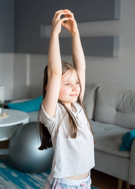 Girl doing stretching at home. Workout at home. - Photo, Image