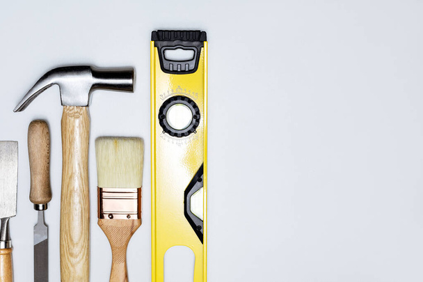 Home repair banner. Construction tools on grey background with copy space. Hand tools for home renovation and construction. - Foto, Imagem