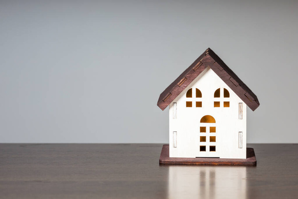 Model House On Grey Background With Copy Space. Concept of buying, mortgage, rent and insurance. - 写真・画像