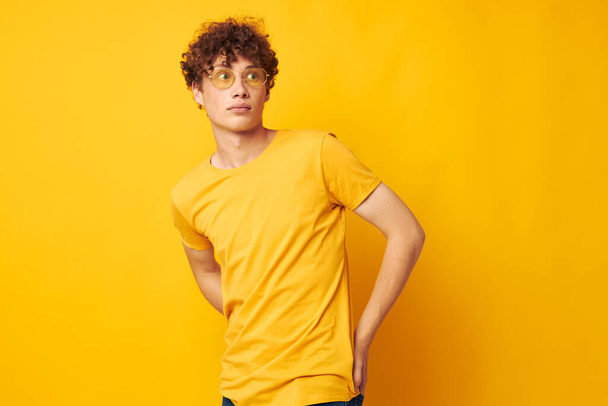 portrait of a young curly man Youth style glasses studio casual wear monochrome shot - Фото, изображение