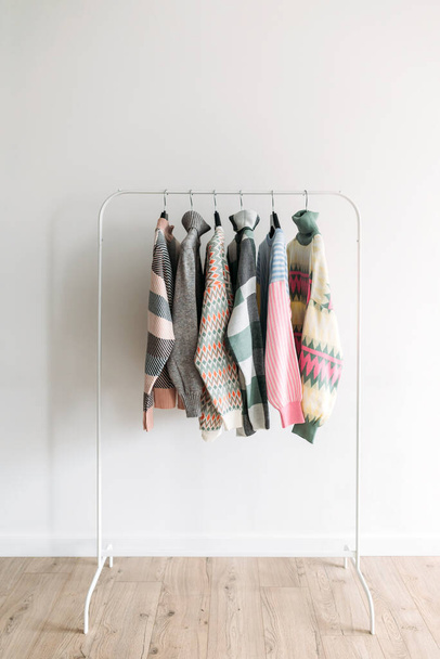 Several colorful patterned clothes on a rack. Showroom - Fotografie, Obrázek