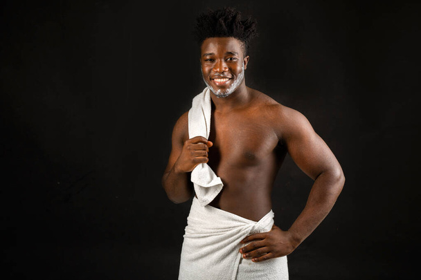 adult cheerful man with a sports figure with a white towel - Photo, image