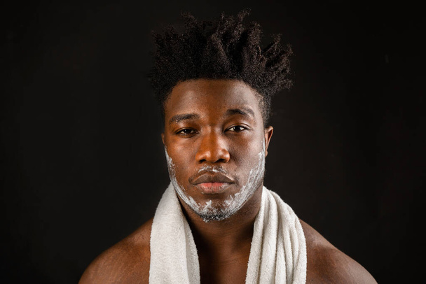 serious african male drying himself with a towel - Photo, image