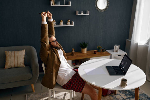 Tired nerd working online from home office - Foto, Bild