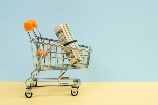 Money dollars shopping basket concept market. Shopping, discounts, sales, black friday. Finance concept - Photo, Image