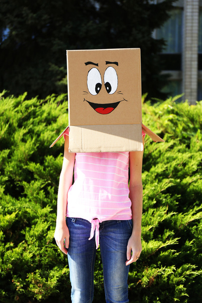 Woman with cardboard box - Фото, изображение
