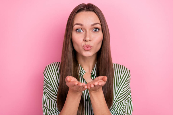 Photo of flirty young brunette lady blow kiss wear shirt isolated on pink color background - 写真・画像