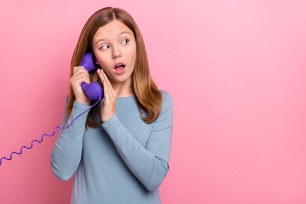 Portrait of attractive worried girl talking on phone secret copy space isolated over pink pastel color background - Foto, Imagen
