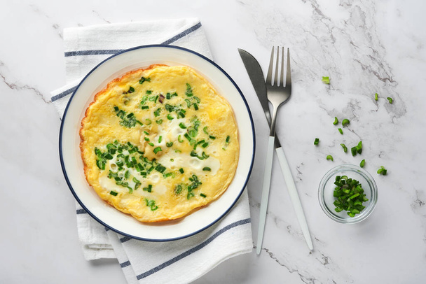 Omelette or frittatas with green onions or young greenery and mozzarella on white marble table background. Healthy food concept. Breakfast. Copy space. Top view. Mock up. - Foto, Imagen