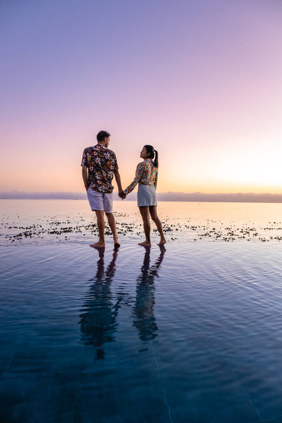 pár muž a žena před Infinity bazénu s výhledem na oceán Kapského Města Jižní Africe, muž a žena v bazénu během západu slunce - Fotografie, Obrázek