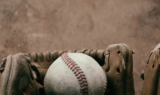 Vintage baseball background with ball and glove close up. - 写真・画像