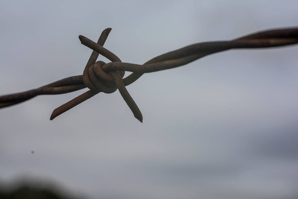 A barbed wire helps to protect a farm and a house in the countryside - Photo, Image