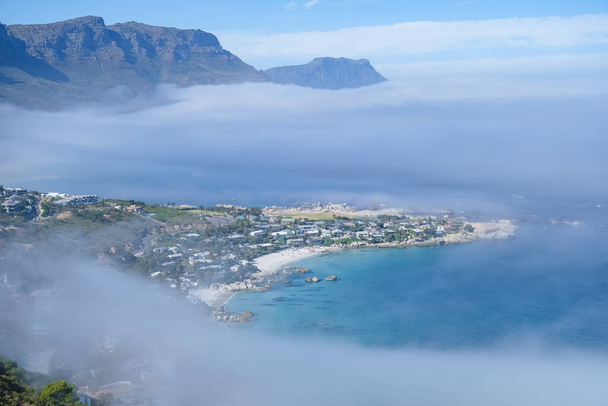 view from The Rock viewpoint in Cape Town over Campsbay, view over Camps Bay with fog over the ocean - Photo, Image