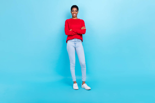 Full size photo of cheerful businesswoman with folded arms wear red shirt and denims isolated blue color background - 写真・画像