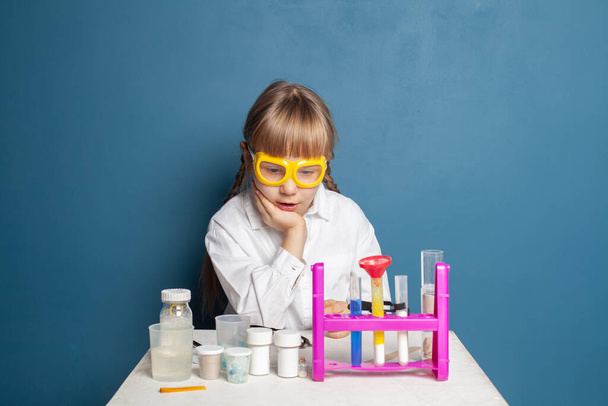 Curious school child learning science and doing science experiment. Science education concept - Photo, Image