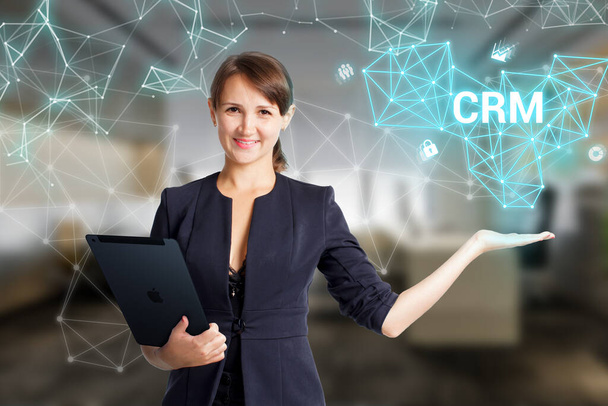 Business, Technology, Internet and network concept. Young businessman working on a virtual screen of the future and sees the inscription: CRM - Φωτογραφία, εικόνα