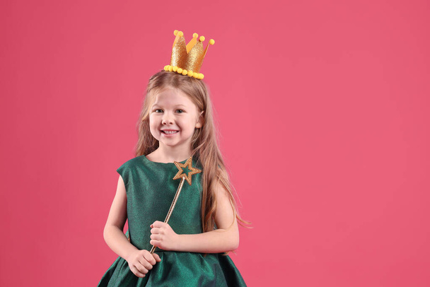 Cute girl in fairy dress with golden crown and magic wand on pink background, space for text. Little princess - Φωτογραφία, εικόνα