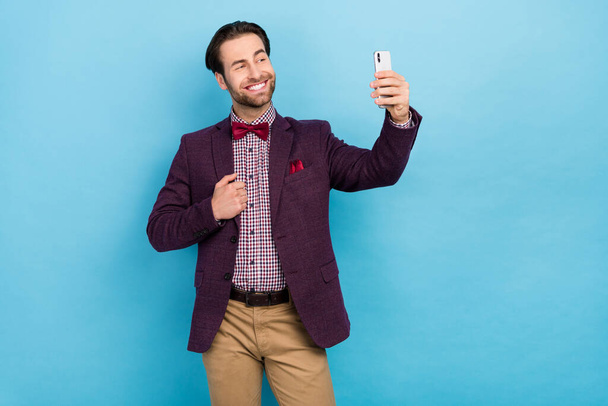 Photo of young cheerful man confident toothy smile shooting selfie mobile isolated over blue color background - Fotografie, Obrázek
