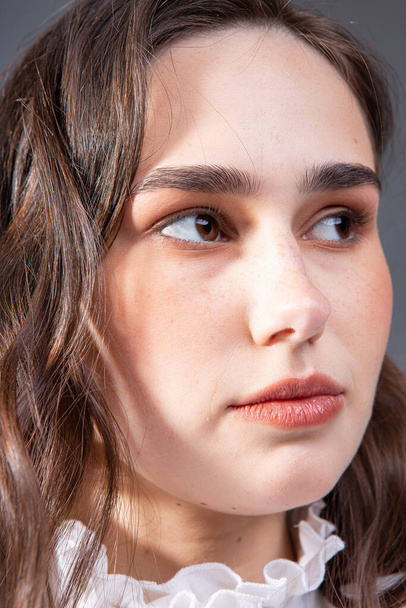 Young woman with long hair with dark brown eyes closeup portrait - Φωτογραφία, εικόνα
