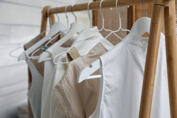 Rack with stylish women's clothes in dressing room, closeup - Foto, afbeelding
