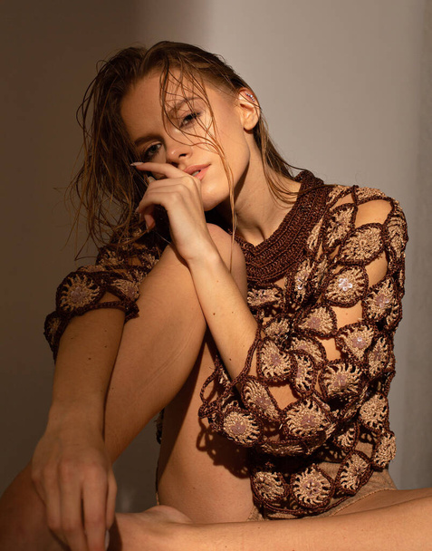 Tanned european young woman with wet hair isolated on dark beige - Fotó, kép