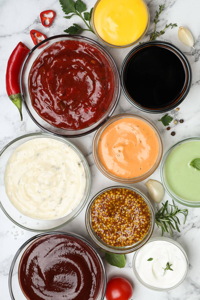 Many different sauces and herbs on white marble table - Foto, Imagem