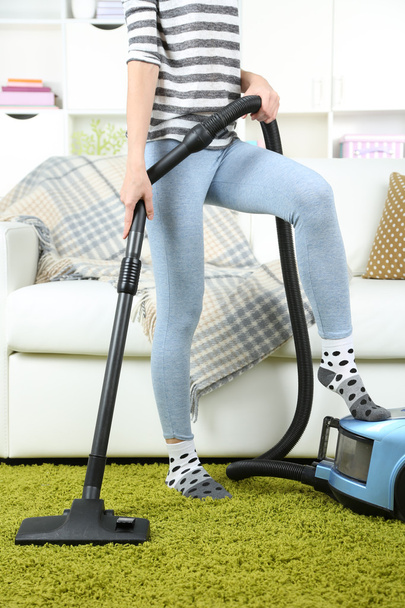Girl vacuuming in room - 写真・画像