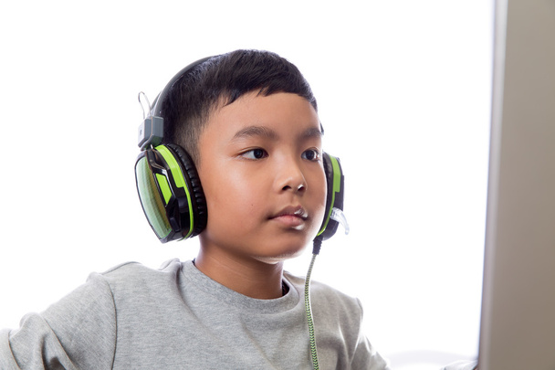 Asian kid play computer games (closeup shot) - Photo, Image