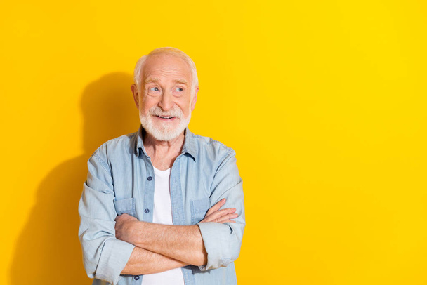 Portrait of attractive cheerful grey-haired man folded arms making solution isolated over bright yellow color background - Photo, Image