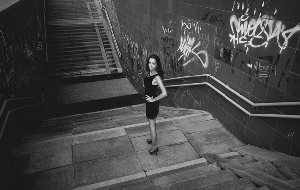 Monochrome shot of sexy girl posing on stairs - Photo, Image