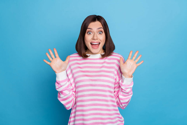 Photo of funny excited lady dressed pink pullover open mouth rising arms isolated blue color background - Fotoğraf, Görsel