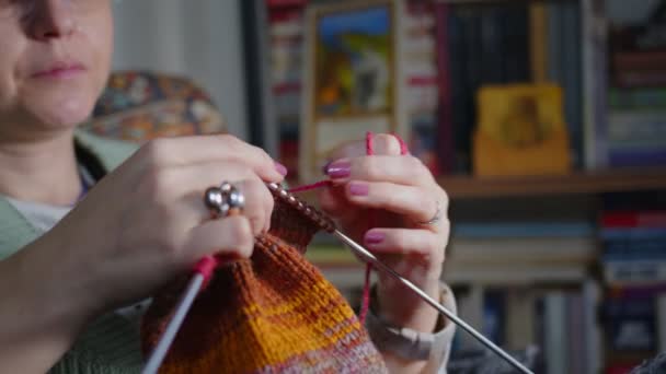 Jovem Mulher Malhas com bolas coloridas de lã e agulhas - Filmagem, Vídeo