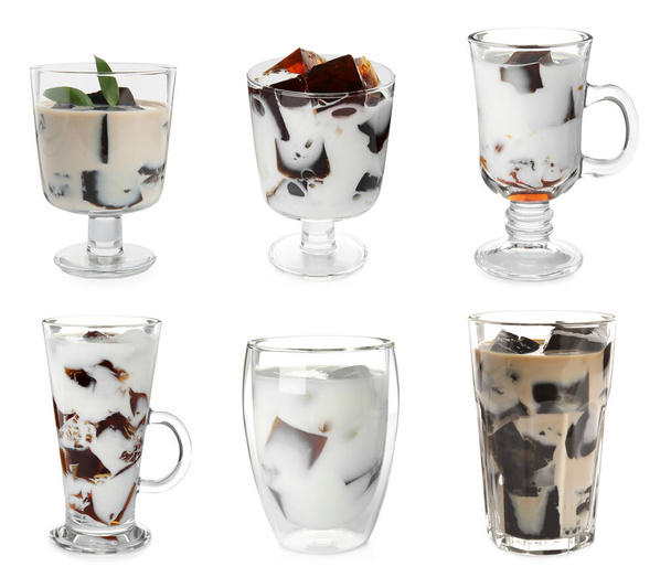 Glasses of milk with tasty grass jelly on white background - Фото, изображение