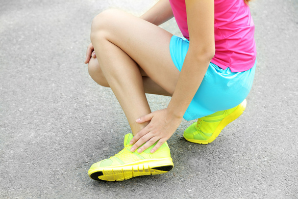 Sports injuries of girl outdoors  - Fotografie, Obrázek