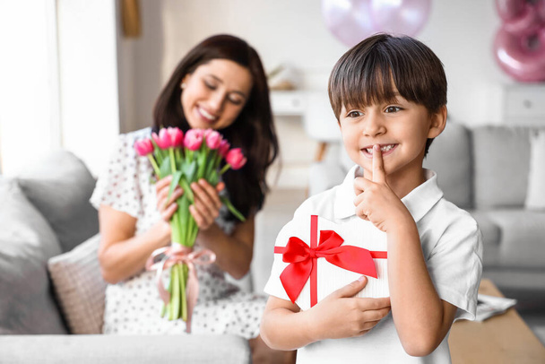 Little boy with gift for his mother for International Women's Day at home - 写真・画像