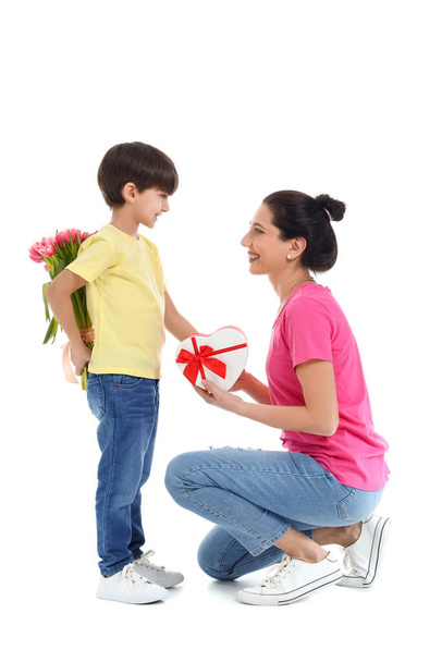 Little son greeting his mother on white background - Foto, Imagem