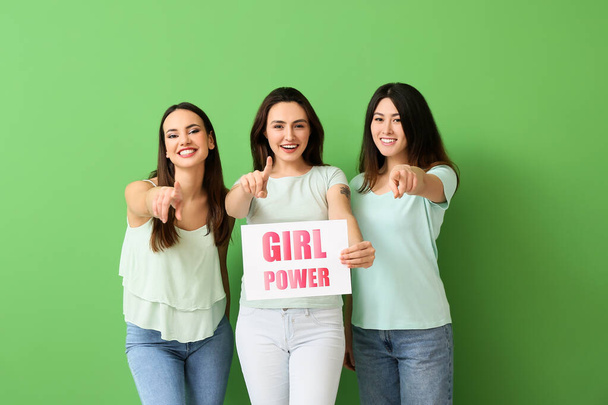 Young women holding paper with text GIRL POWER on green background - Photo, Image
