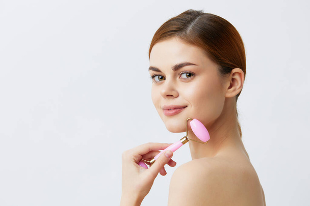 pretty woman with massage roller on  isolated background. High quality photo - Zdjęcie, obraz
