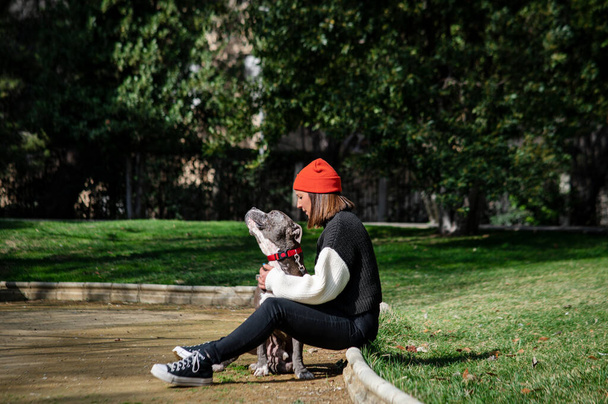 Young girl with her dog in the park in the summertime - Photo, image