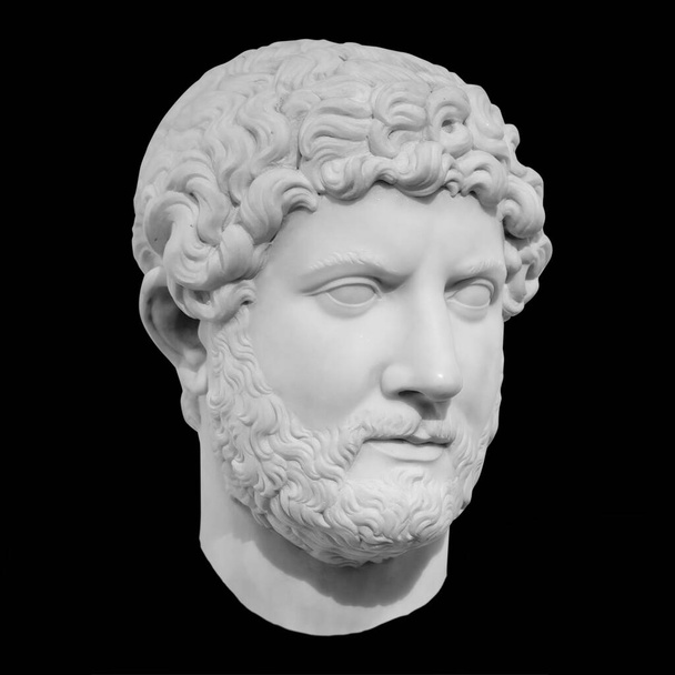 Ancient marble sculpture of the roman emperor Hadrian isolated on black with clipping path - Фото, зображення