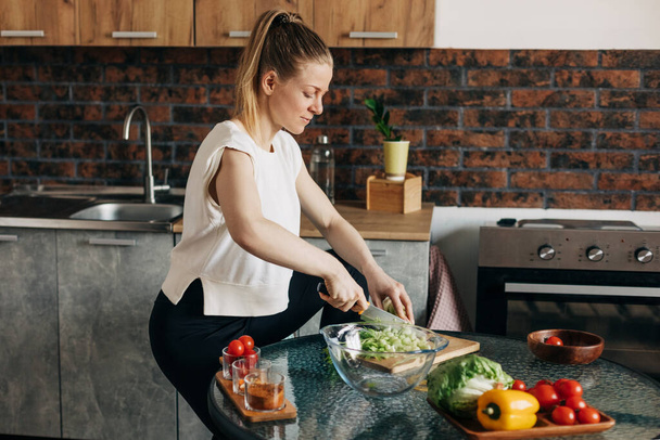 Sports woman cooking healthy eat at home - Fotó, kép
