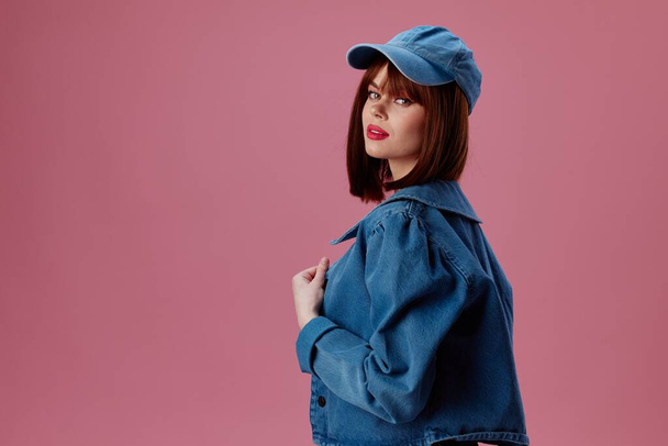 Beauty Fashion woman in  denim cap posing on  pink background unaltered. High quality photo - Foto, immagini
