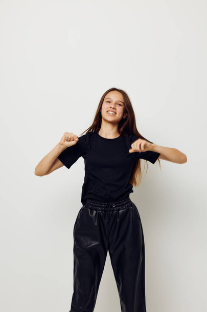 beautiful girl in black pants and a T-shirt fashion isolated background - Photo, image